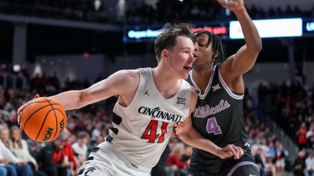 Cincinnati Bearcats guard Simas Lukosius (41) drives around Kansas State Wildcats guard Dai Dai Ames (4) in the first half of the NCAA Big 12 basketball game between the Cincinnati Bearcats and the Kansas State Wildcats at Fifth Third Arena in Cincinnati on Saturday, March 2, 2024.